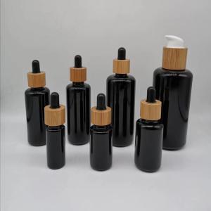 Wholesale 10ml 15ml 30ml 50ml 100ml 200ml Black round shoulder essential oil empty cosmetic glass bottles with bamboo dropper from china suppliers