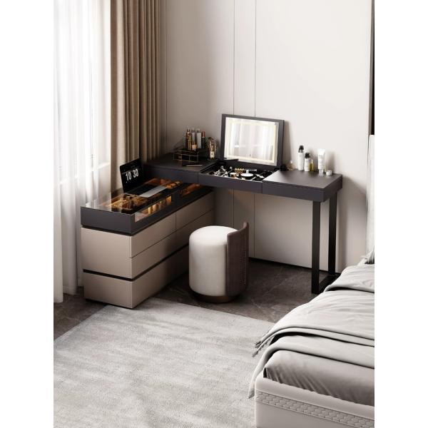 Dark wood dressing table with velvet upholstery in bedroom setting